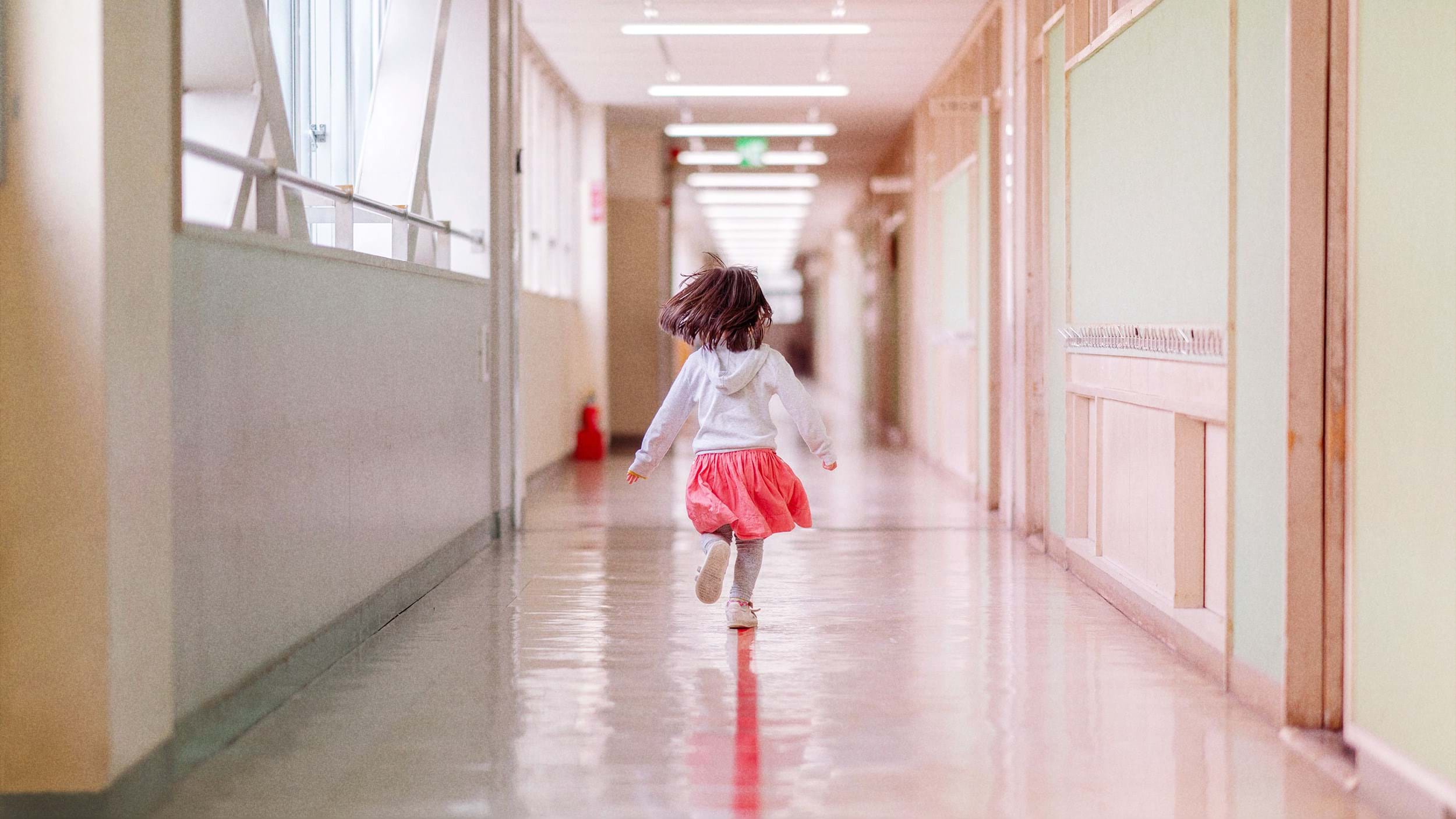 Girl running down corridor