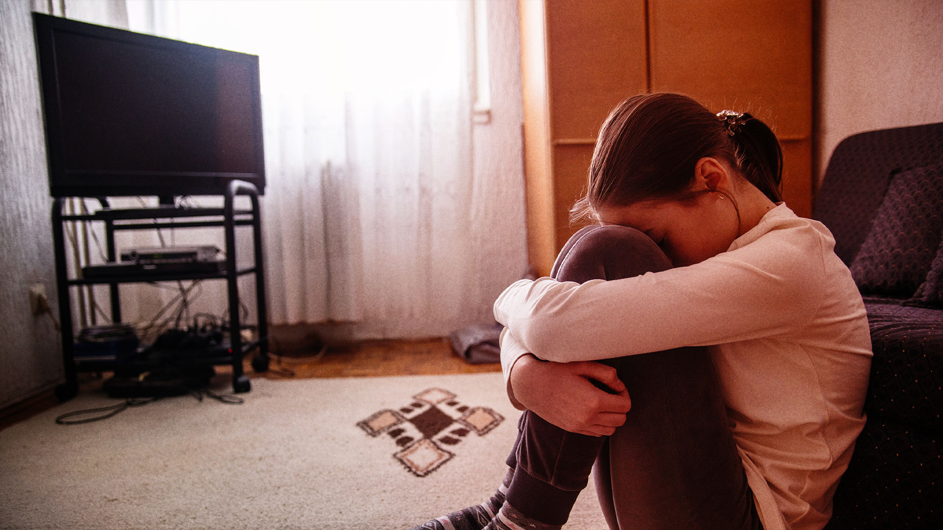 Sad girl with head in hands