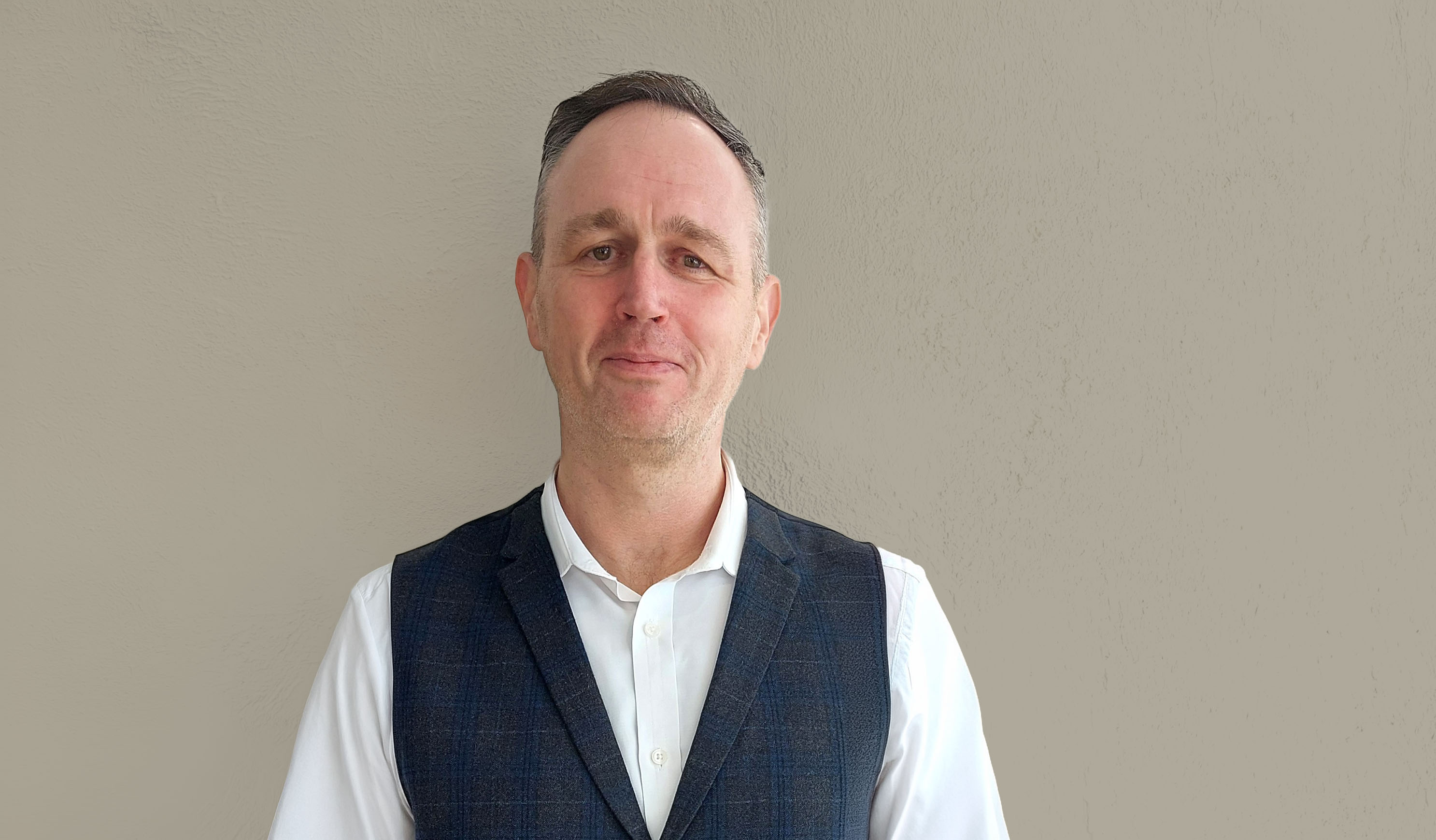 Image of Shaun Friel against a grey plastered effect wall