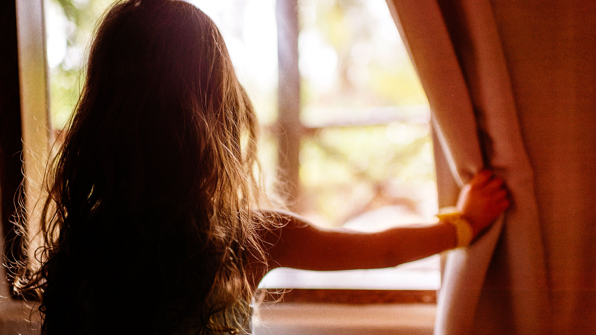 Girl looking through the window