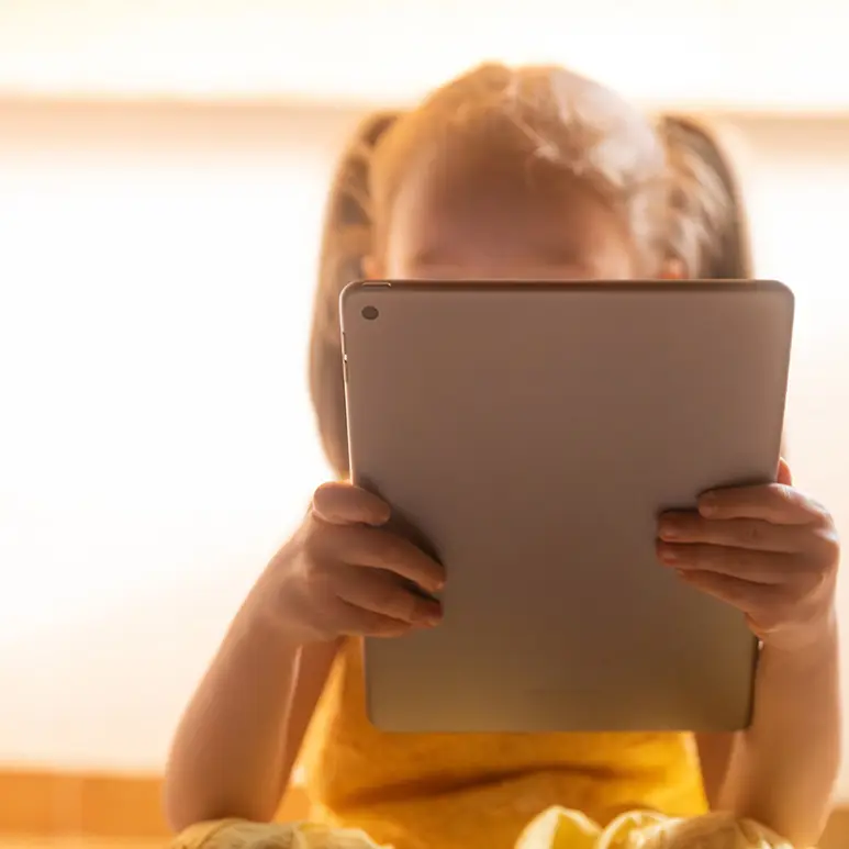 A girl holding a tablet 