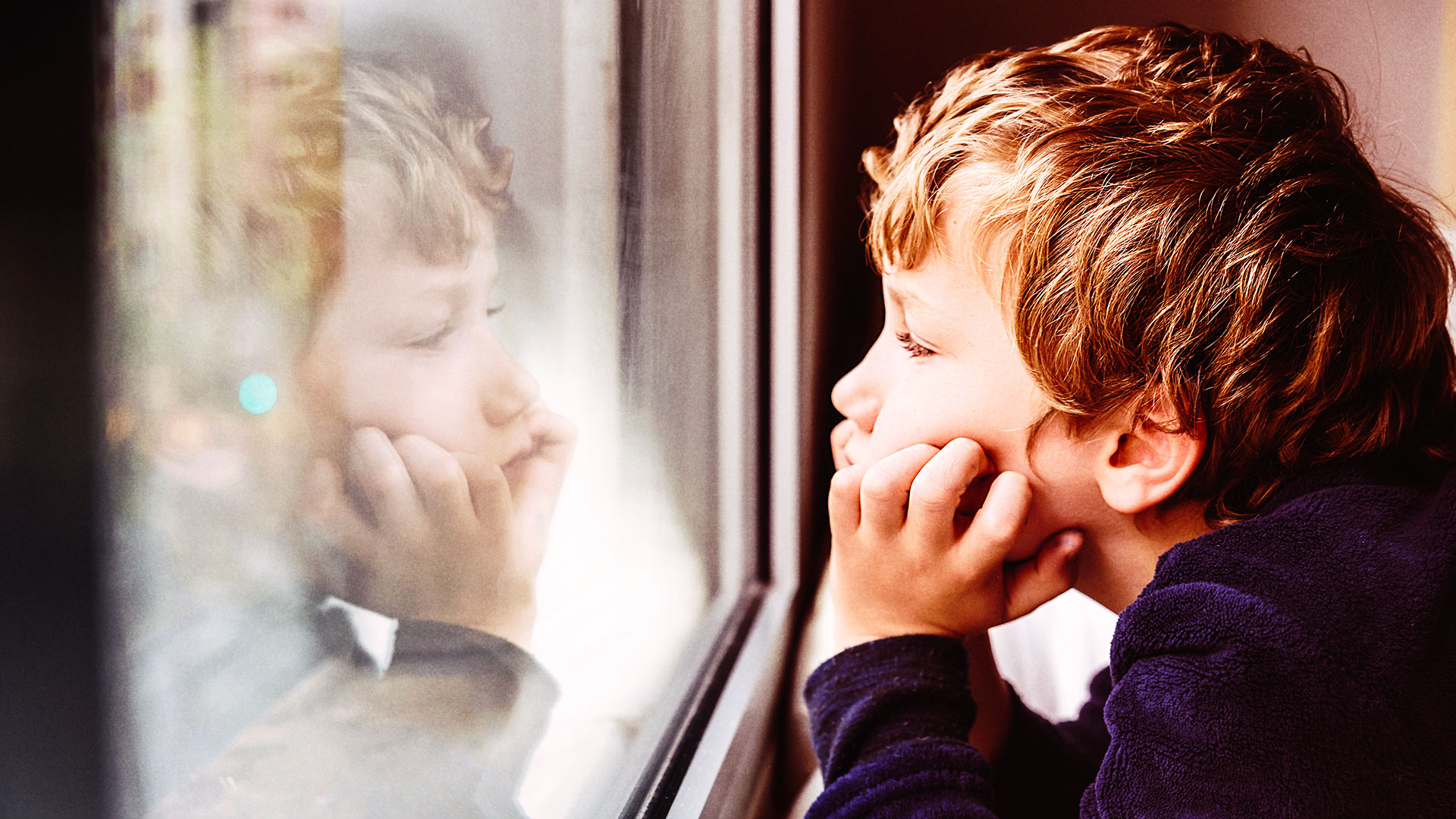 Child looking through the window