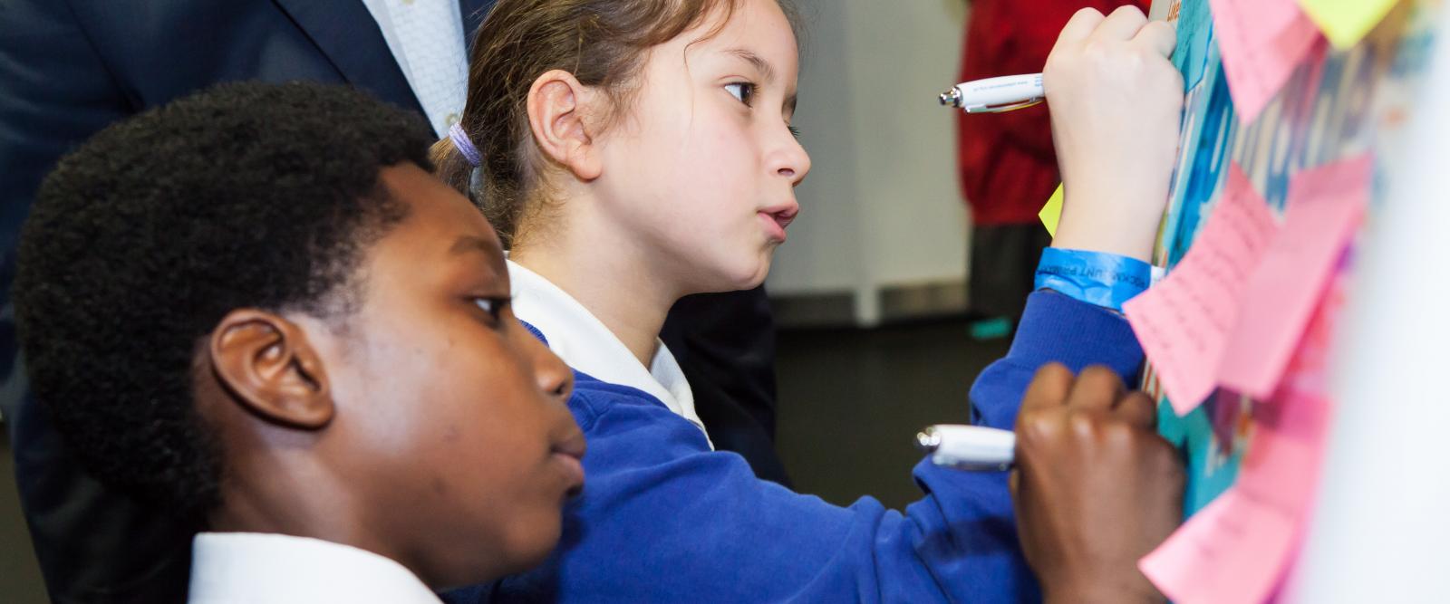 Children writing on paper