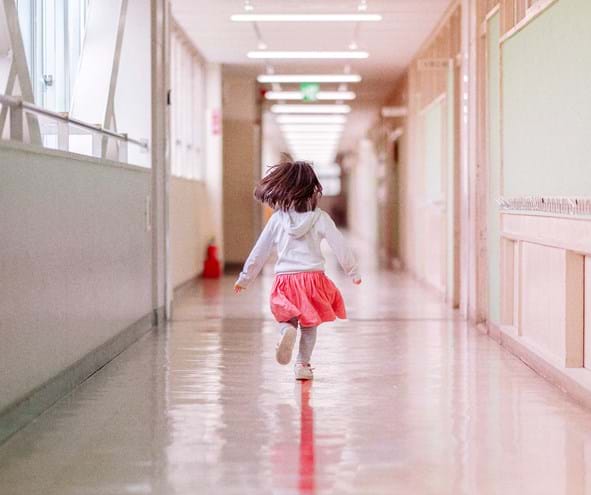 Girl running down corridor